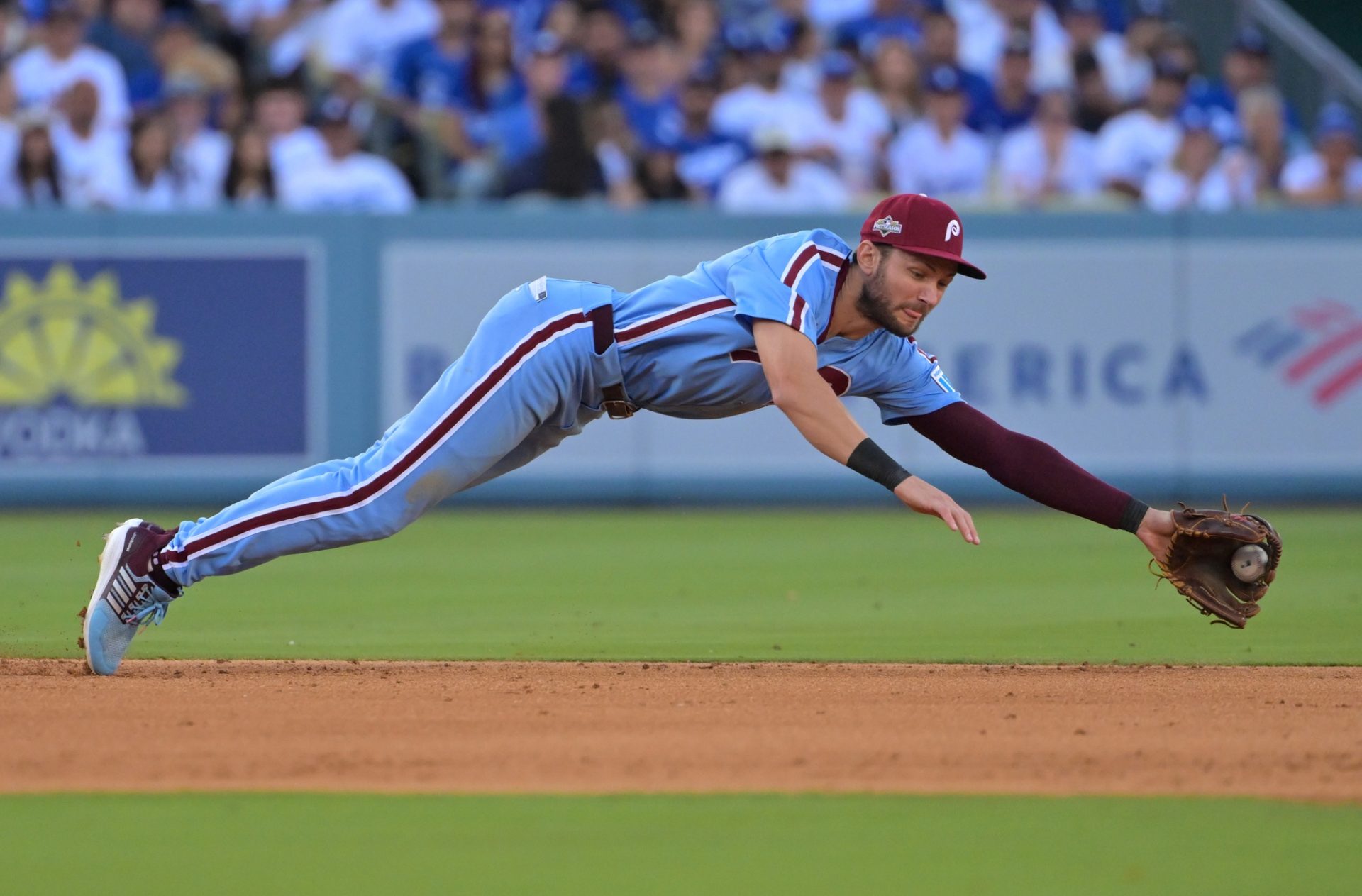 Oct 9, 2025; Los Angeles, California, USA; Philadelphia Phillies shortstop Trea Turner (7) fields a ground ball and throws to first for an out in the seventh inning against the Los Angeles Dodgers during game four of the NLDS round for the 2025 MLB playoffs at Dodger Stadium.