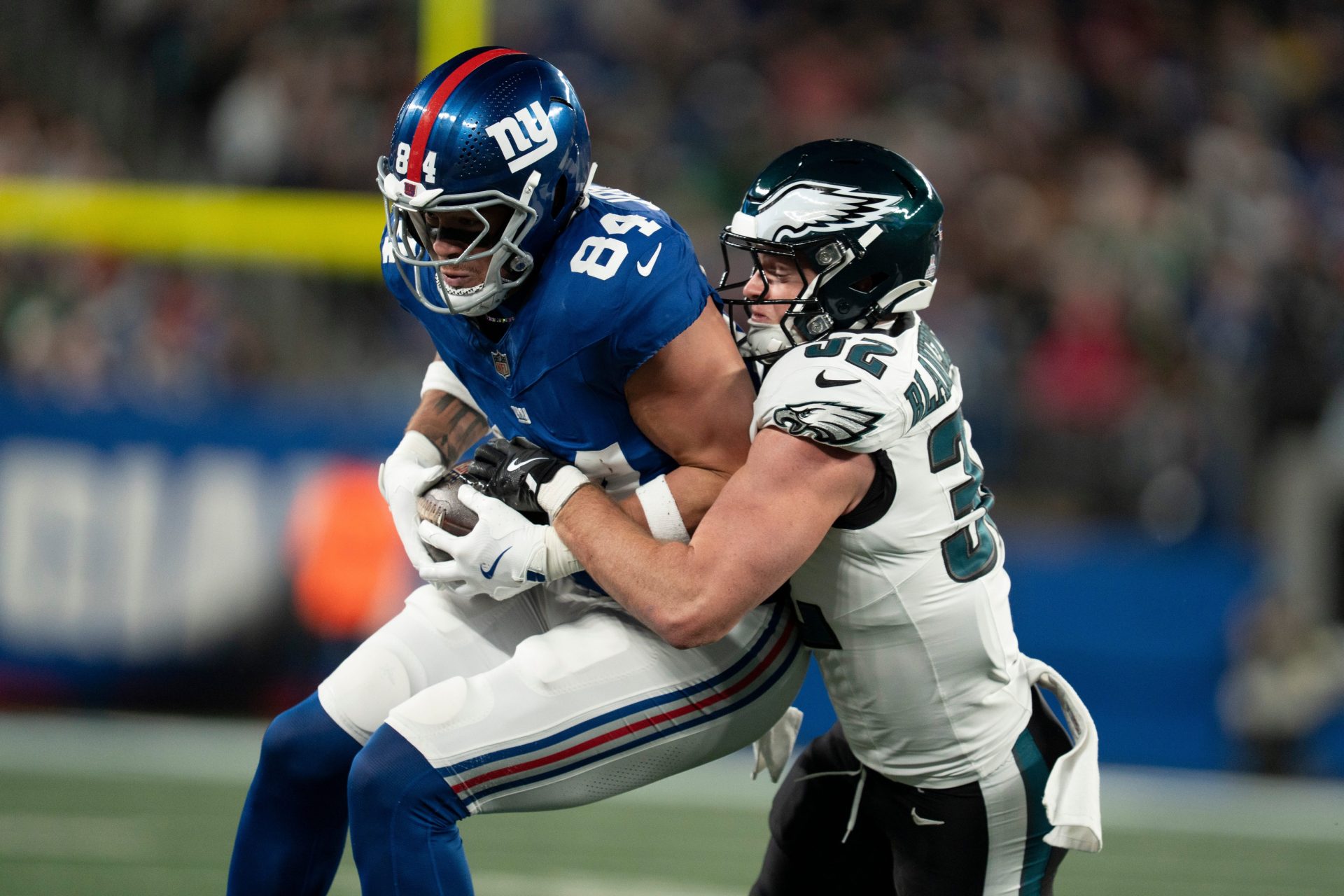 New York Giants tight end Theo Johnson (84) catches a pass before being tackled by Philadelphia Eagles safety Reed Blankenship (32) during a Thursday Night Football game between the New York Giants and the Philadelphia Eagles at MetLife Stadium in East Rutherford on Oct. 9, 2025.