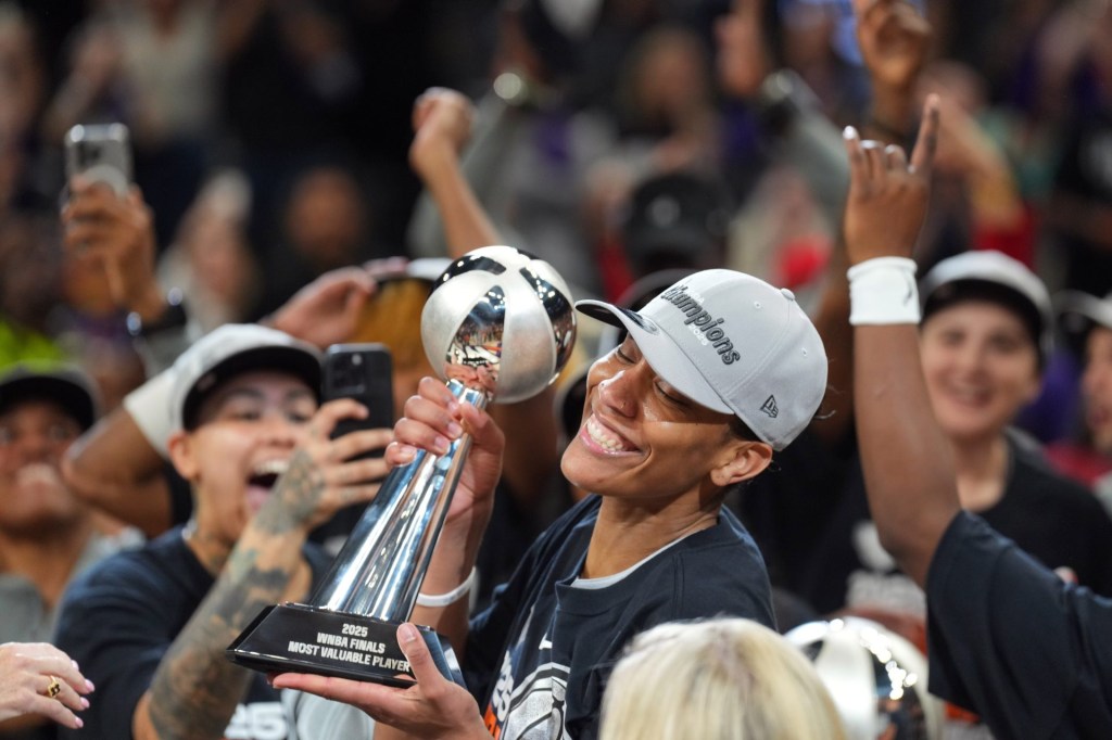 Oct 10, 2025; Phoenix, Arizona, USA; Las Vegas Aces center A'ja Wilson (22) celebrates with teammates after game four of the 2025 WNBA Finals at Mortgage Matchup Center.