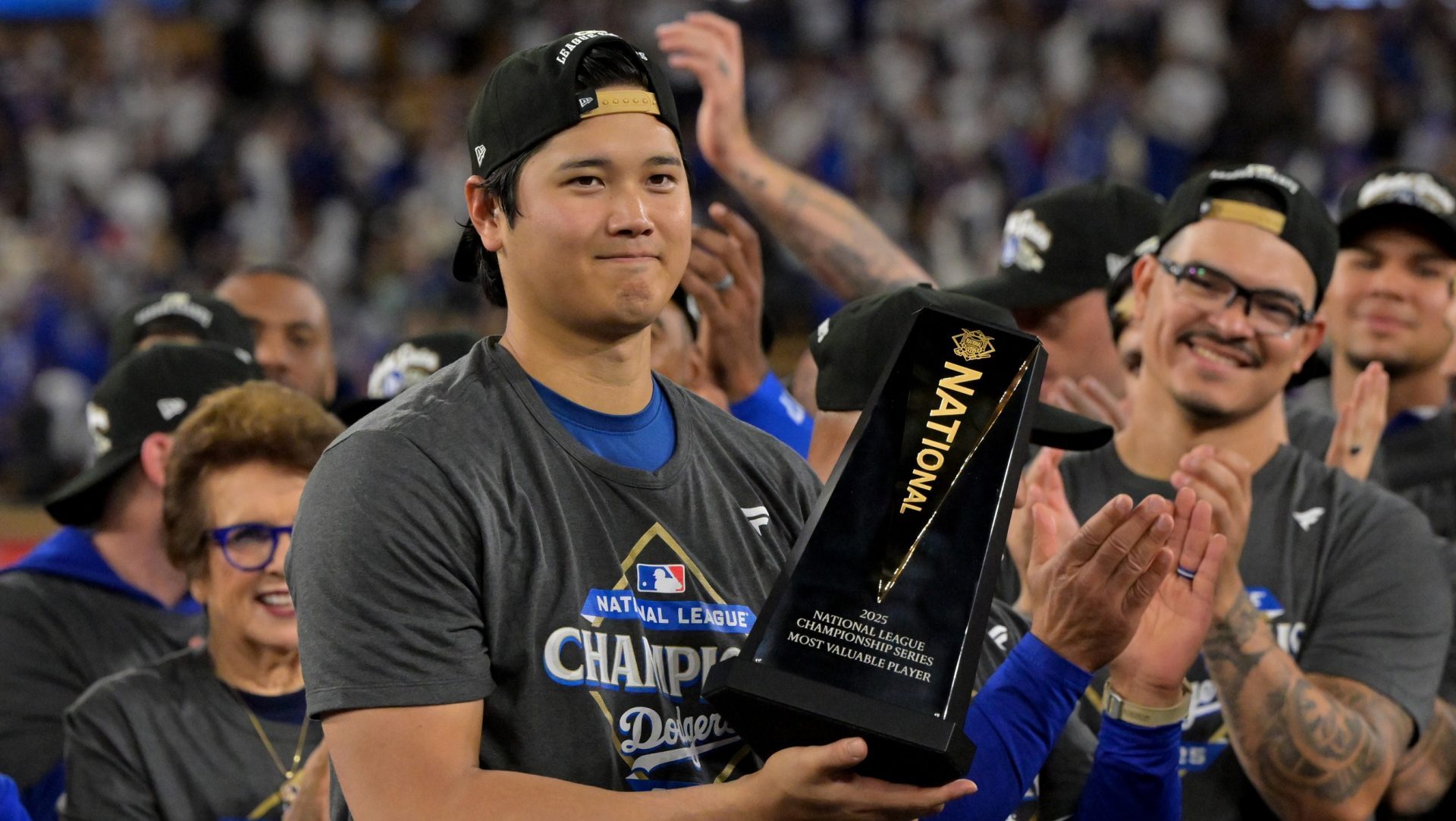 Oct 18, 2025; Los Angeles, California, USA; Los Angeles Dodgers two-way player Shohei Ohtani (17) holds the MVP trophy after defeating the Milwaukee Brewers in game five of the NLCS during the 2025 MLB playoffs at Dodger Stadium.
