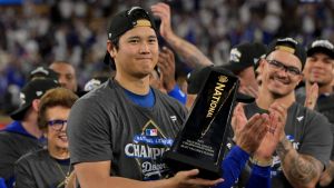 Oct 18, 2025; Los Angeles, California, USA; Los Angeles Dodgers two-way player Shohei Ohtani (17) holds the MVP trophy after defeating the Milwaukee Brewers in game five of the NLCS during the 2025 MLB playoffs at Dodger Stadium.