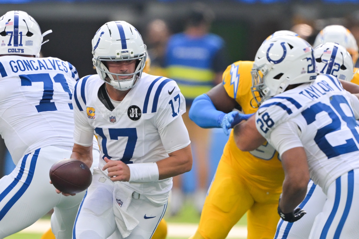 Oct 19, 2025; Inglewood, California, USA; Indianapolis Colts quarterback Daniel Jones (17) hands off the ball in the first quarter against the Los Angeles Chargers at SoFi Stadium.