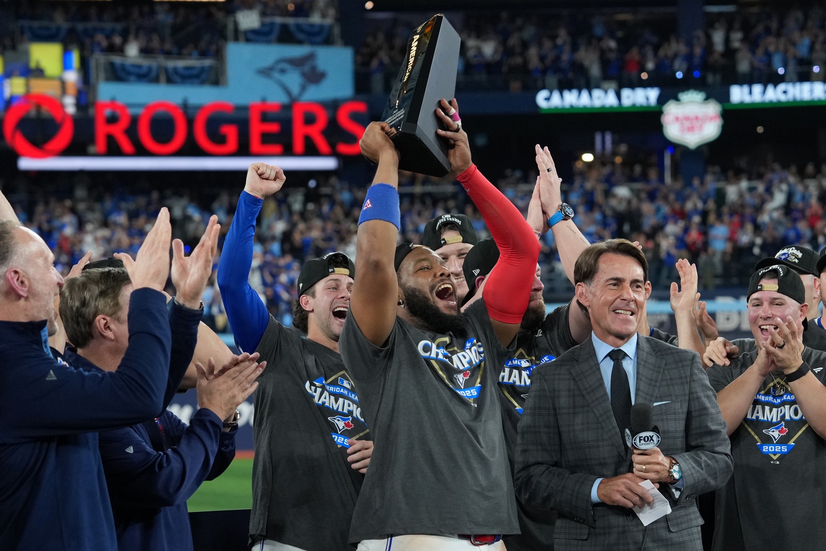 Oct 20, 2025; Toronto, Ontario, CAN; Toronto Blue Jays first baseman Vladimir Guerrero Jr. (27) celebrates with the trophy after defeating the Seattle Mariners in game seven of the ALCS round for the 2025 MLB playoffs at Rogers Centre.