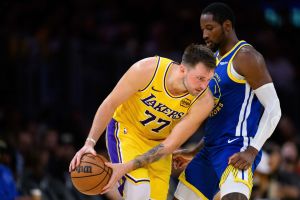 Oct 21, 2025; Los Angeles, California, USA; Los Angeles Lakers guard Luka Doncic (77) looks to drive against Golden State Warriors forward Jonathan Kuminga (1) during the second half at Crypto.com Arena.