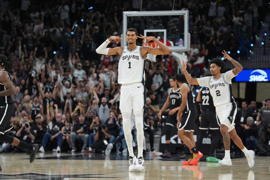 Oct 26, 2025; San Antonio, Texas, USA; San Antonio Spurs forward Victor Wembanyama (1) celebrates a three-point shot in the second half against the Brooklyn Nets at Frost Bank Center.