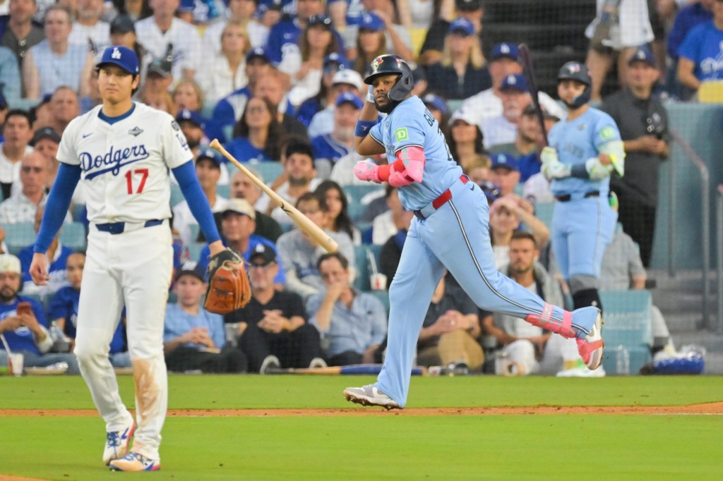 Oct 28, 2025; Los Angeles, California, USA; Toronto Blue Jays first baseman Vladimir Guerrero Jr. (27) throws his bat after hitting a two run home run as Los Angeles Dodgers two-way player Shohei Ohtani (17) looks on during the third inning of game four of the 2025 MLB World Series at Dodger Stadium.