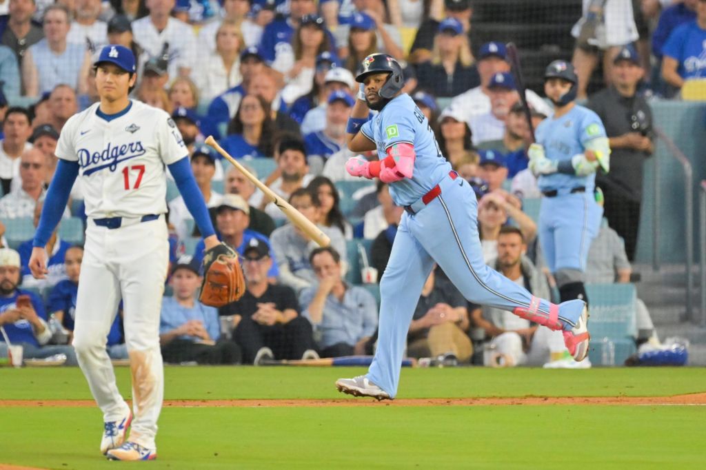 Oct 28, 2025; Los Angeles, California, USA; Toronto Blue Jays first baseman Vladimir Guerrero Jr. (27) throws his bat after hitting a two run home run as Los Angeles Dodgers two-way player Shohei Ohtani (17) looks on during the third inning of game four of the 2025 MLB World Series at Dodger Stadium.