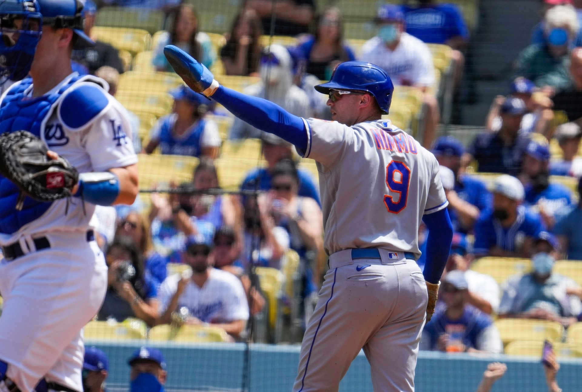 Aug 22, 2021; Los Angeles, California, USA; New York Mets centerfielder Brandon Nimmo (9) waves to Javier Bez (not pictured) after scoring on his first inning double against the Los Angeles Dodgers at Dodger Stadium.