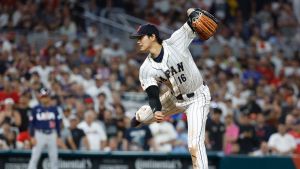 Mar 21, 2023; Miami, Florida, USA; Japan designated hitter and closing pitcher Shohei Ohtani (16) pitches against the USA in the ninth inning at LoanDepot Park.