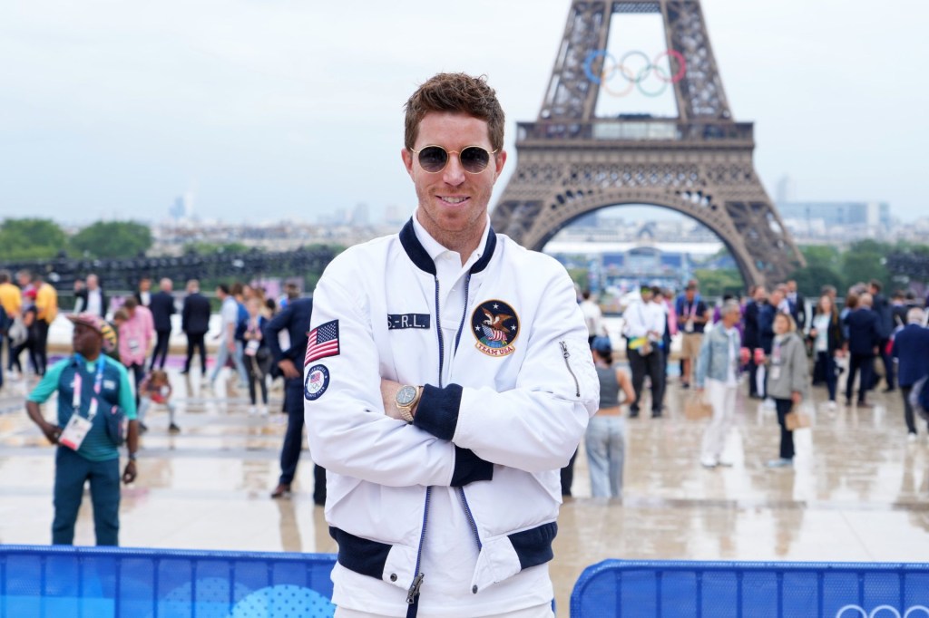 Jul 26, 2024; Paris, FRANCE; Shaun White poses for a photo in front of the Eiffel Tower before the Opening Ceremony for the Paris 2024 Olympic Summer Games.