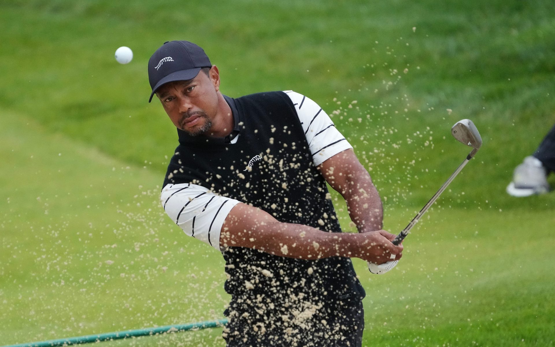 Tiger Woods htis a bunker shot on the 3rd green during a practice round in the PGA Championship at the Valhalla Golf Course in Louisville, Ky. on May. 14, 2024.