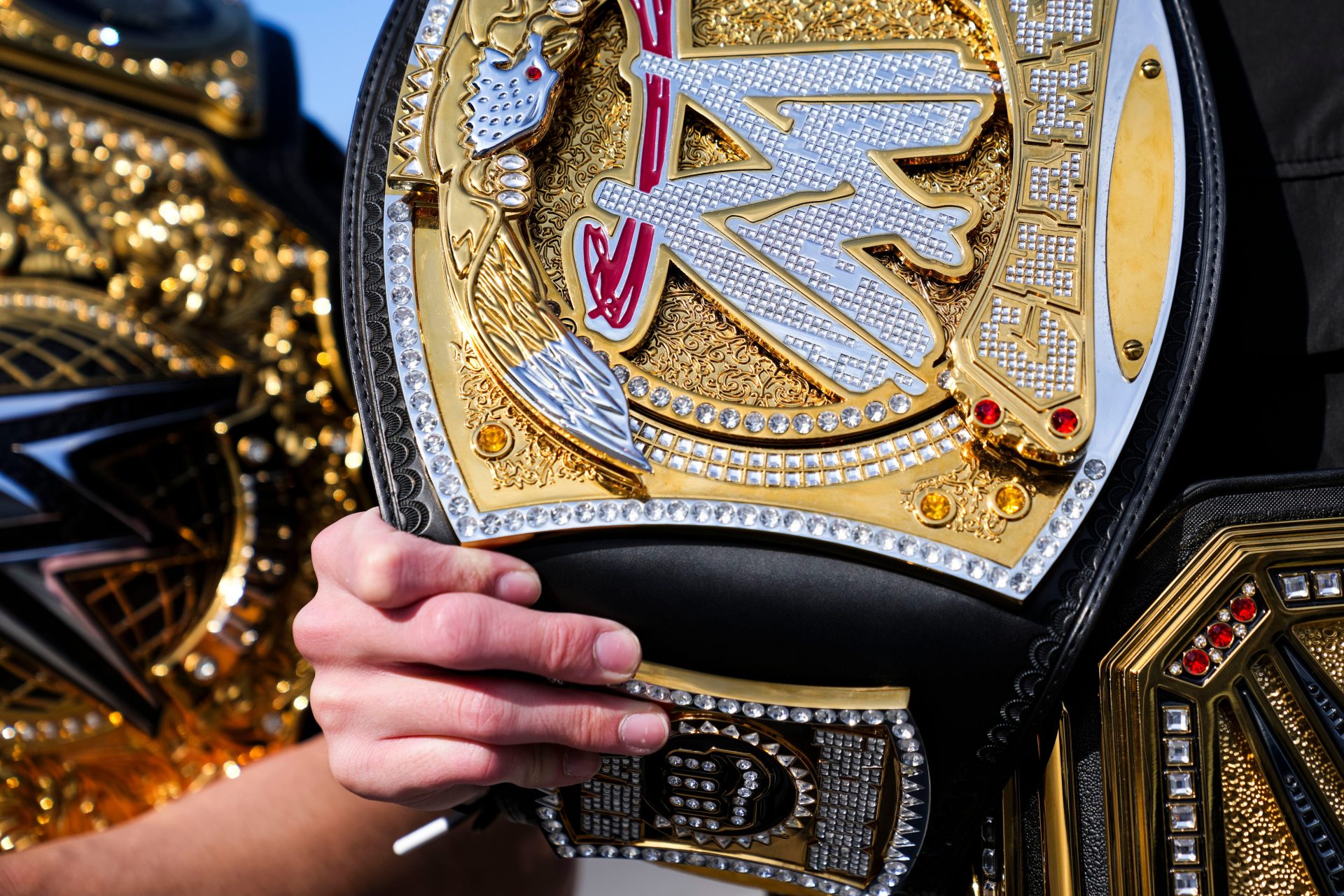 Santana Moore from Kansas City holds a belt Saturday, Feb. 1, 2025, as WWE fans crowd downtown Indianapolis ahead of the Royal Rumble at Lucas Oil Stadium.