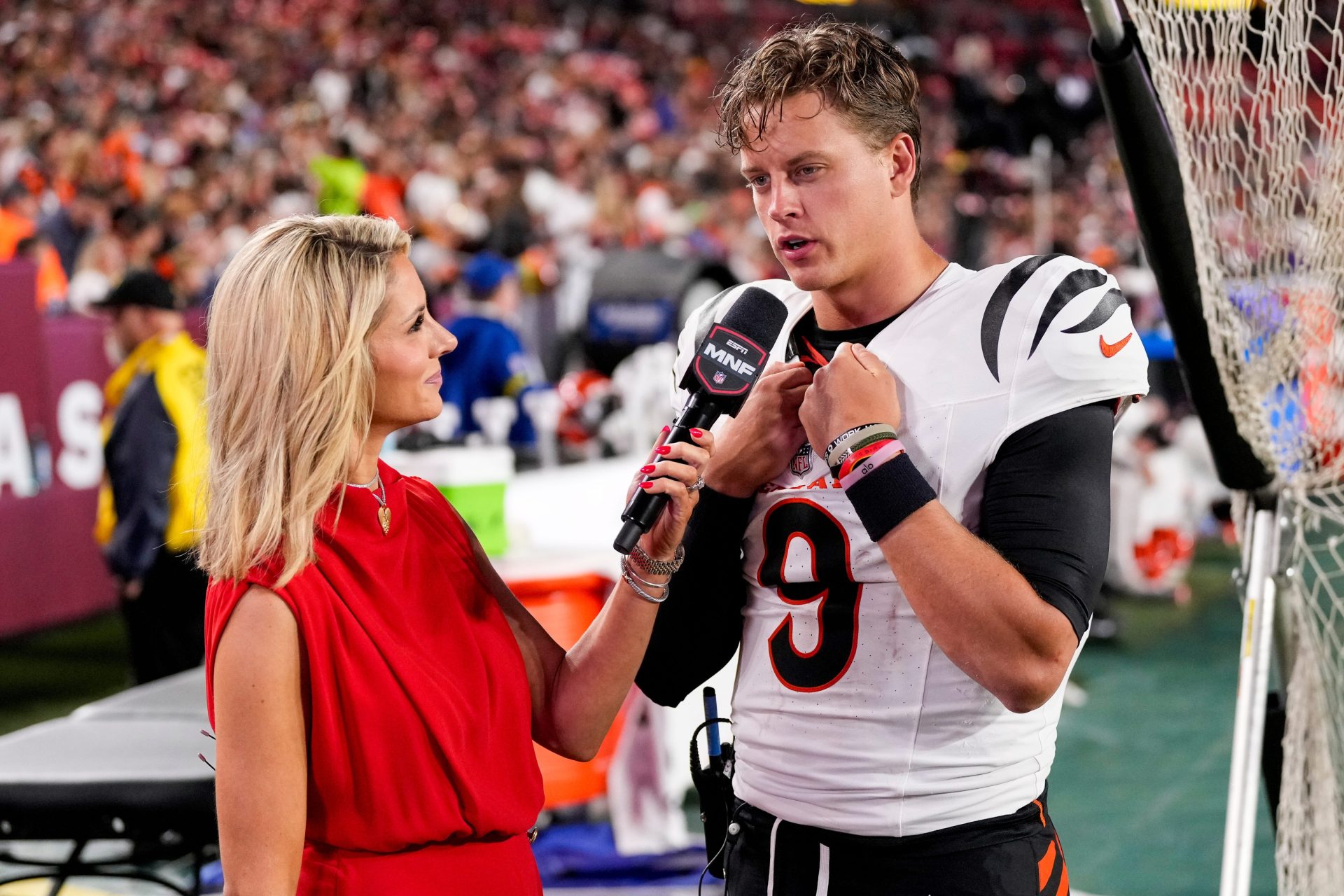 Cincinnati Bengals quarterback Joe Burrow (9) is interviewed by sideline reporter Laura Rutledge in the third quarter of the NFL Preseason Week 2 game between the Washington Commanders and the Cincinnati Bengals at Northwest Stadium in Landover, Md., on Monday, Aug. 18, 2025. The Bengals won the game, 31-17.