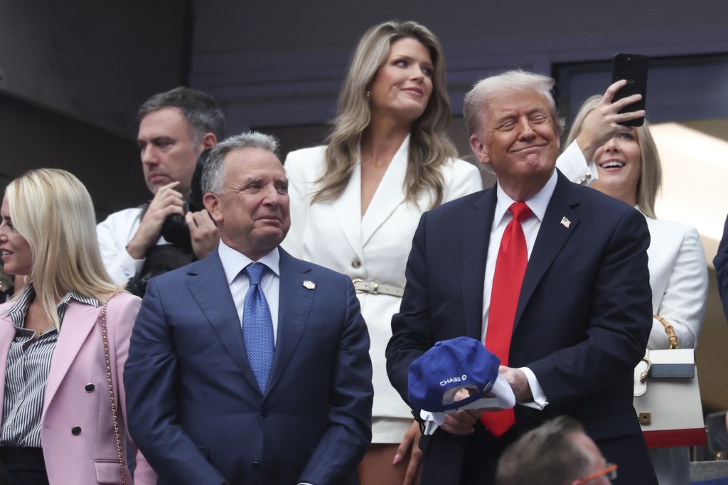 Sep 7, 2025; Flushing, NY, USA; President Donald Trump signs hats after the final of mens singles at Billie Jean King National Tennis Center.