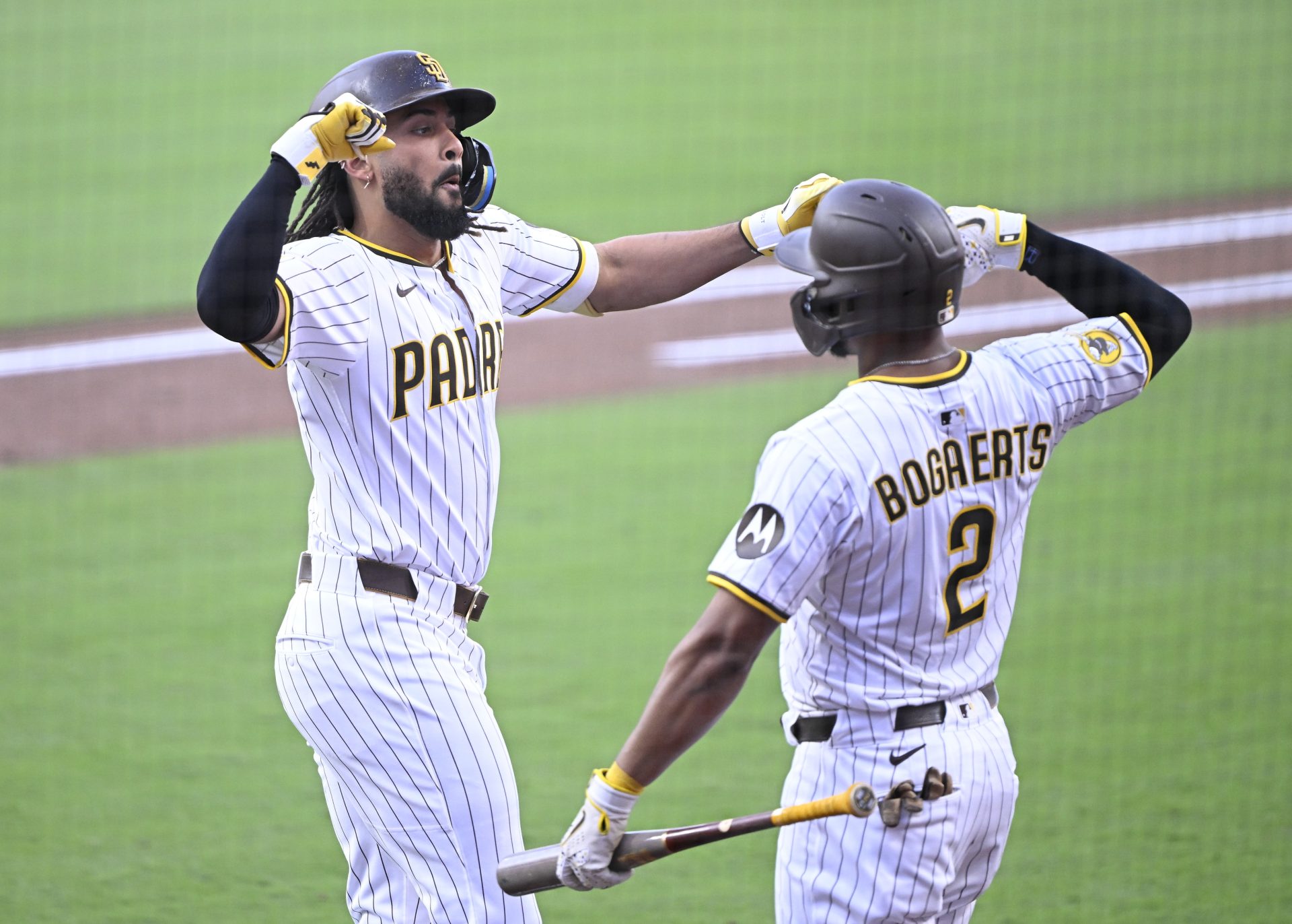 Sep 27, 2025; San Diego, California, USA; San Diego Padres right fielder Fernando Tatis Jr. (23) is congratulated by Luis Arraez (4) after hitting a solo home run during the first inning against the Arizona Diamondbacks at Petco Park.