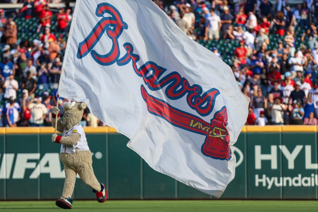Sep 28, 2025; Cumberland, Georgia, USA; The Atlanta Braves mascot Blooper runs with the Atlanta Braves flag after a victory against the Pittsburgh Pirates at Truist Park.