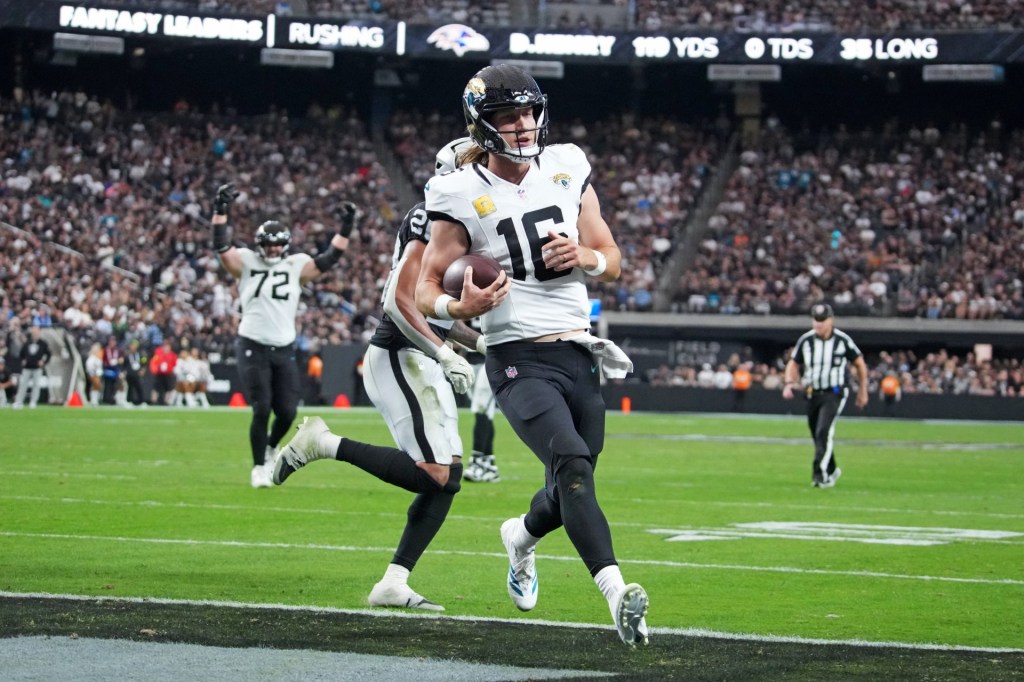 Nov 2, 2025; Paradise, Nevada, USA; Jacksonville Jaguars quarterback Trevor Lawrence (16) scores a touchdown during the second half against the Las Vegas Raiders at Allegiant Stadium.