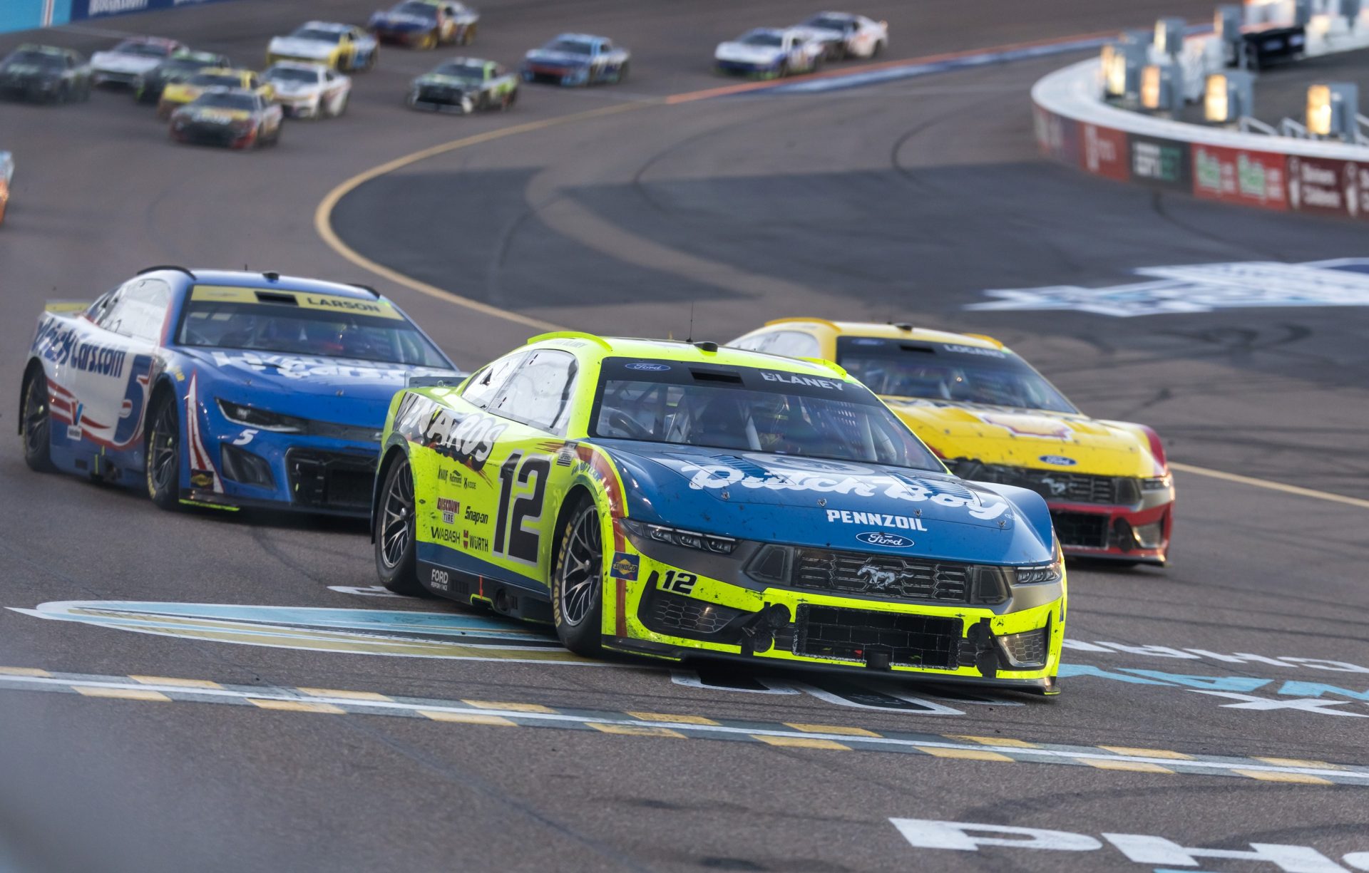 Nov 2, 2025; Avondale, Arizona, USA; NASCAR Cup Series driver Ryan Blaney crosses the finish line to win the NASCAR Championship race at Phoenix Raceway.