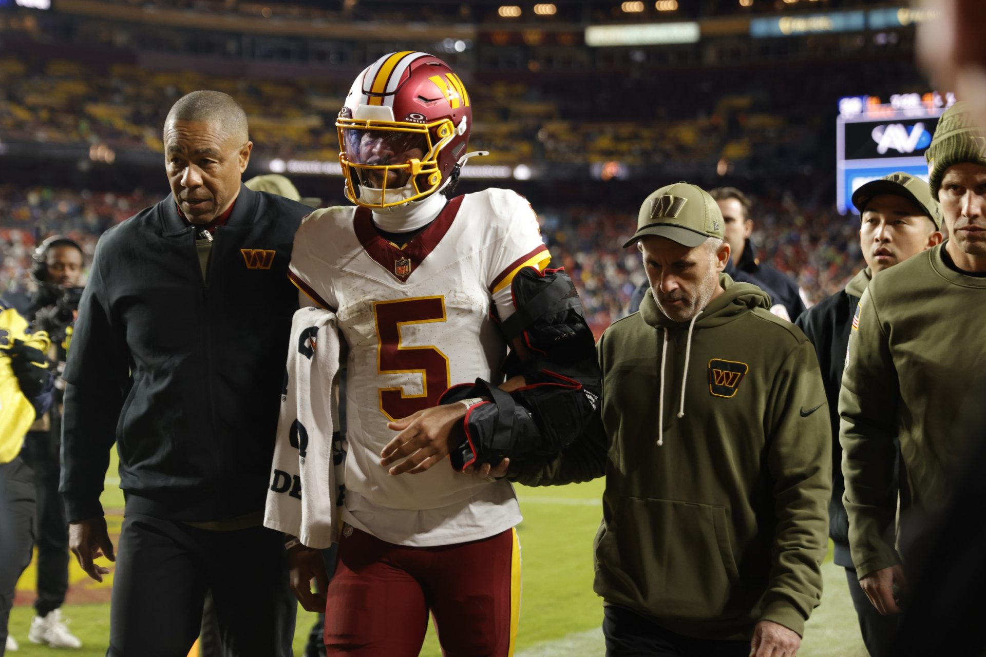 Nov 2, 2025; Landover, Maryland, USA; Washington Commanders quarterback Jayden Daniels (5) is helped off the field after an injury during the second half against the Seattle Seahawks at Northwest Stadium.
