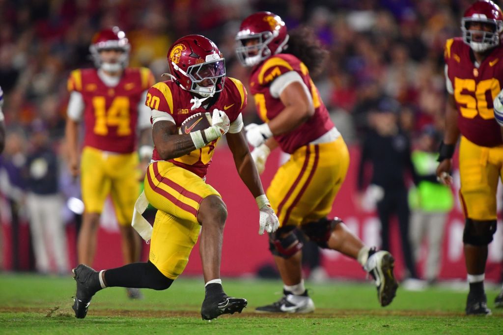 Nov 7, 2025; Los Angeles, California, USA; Southern California Trojans running back King Miller (30) runs the ball against the Northwestern Wildcats during the second half at the Los Angeles Memorial Coliseum.
