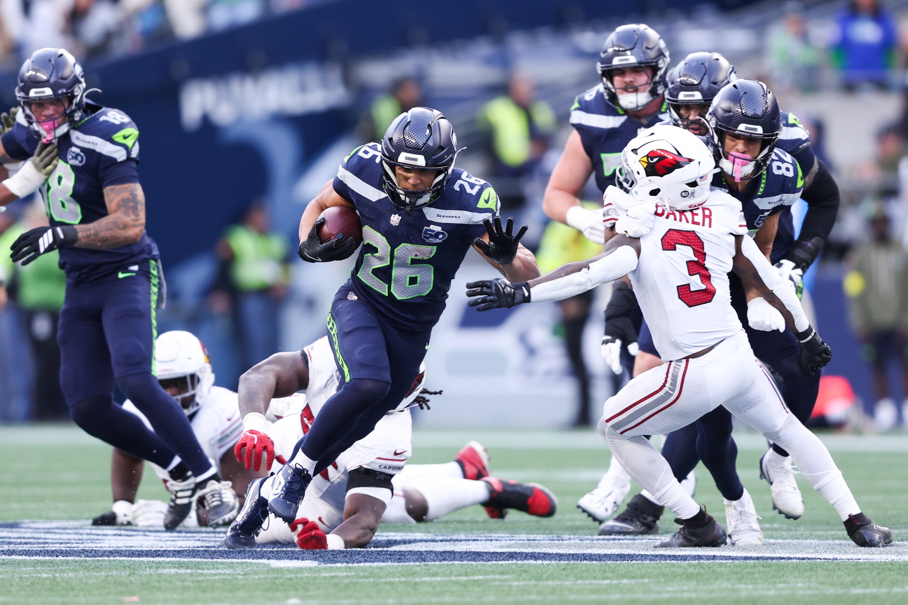 Nov 9, 2025; Seattle, Washington, USA; Seattle Seahawks running back Zach Charbonnet (26) rushes during the fourth quarter against the Arizona Cardinals at Lumen Field.