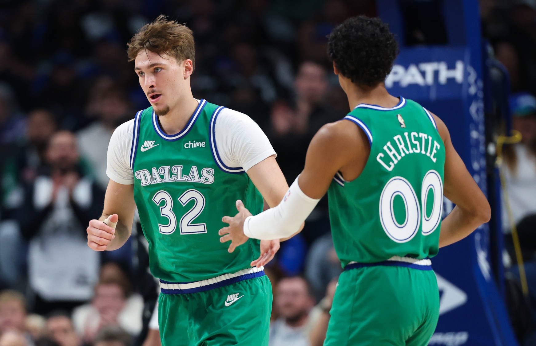 Nov 10, 2025; Dallas, Texas, USA; Dallas Mavericks forward Cooper Flagg (32) celebrates with Dallas Mavericks guard Max Christie (00) during the first quarter against the Milwaukee Bucks at American Airlines Center.