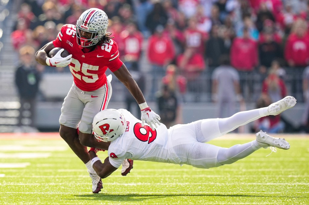 Ohio State Buckeyes running back Bo Jackson (25) runs the ball against Rutgers Scarlet Knights defensive back Jett Elad (9) in the first half of the NCAA football game at Ohio Stadium on Saturday, Nov. 22, 2025 in Columbus, Ohio.
