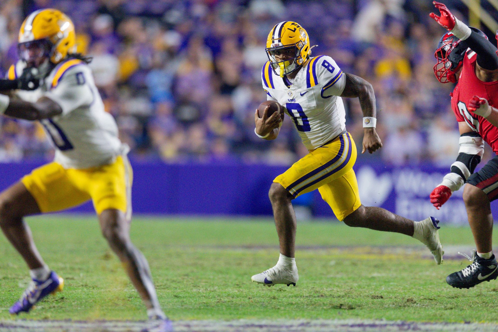 Nov 22, 2025; Baton Rouge, Louisiana, USA; LSU Tigers quarterback Ju'Juan Johnson (8) runs against the Western Kentucky Hilltoppers during the second half at Tiger Stadium.