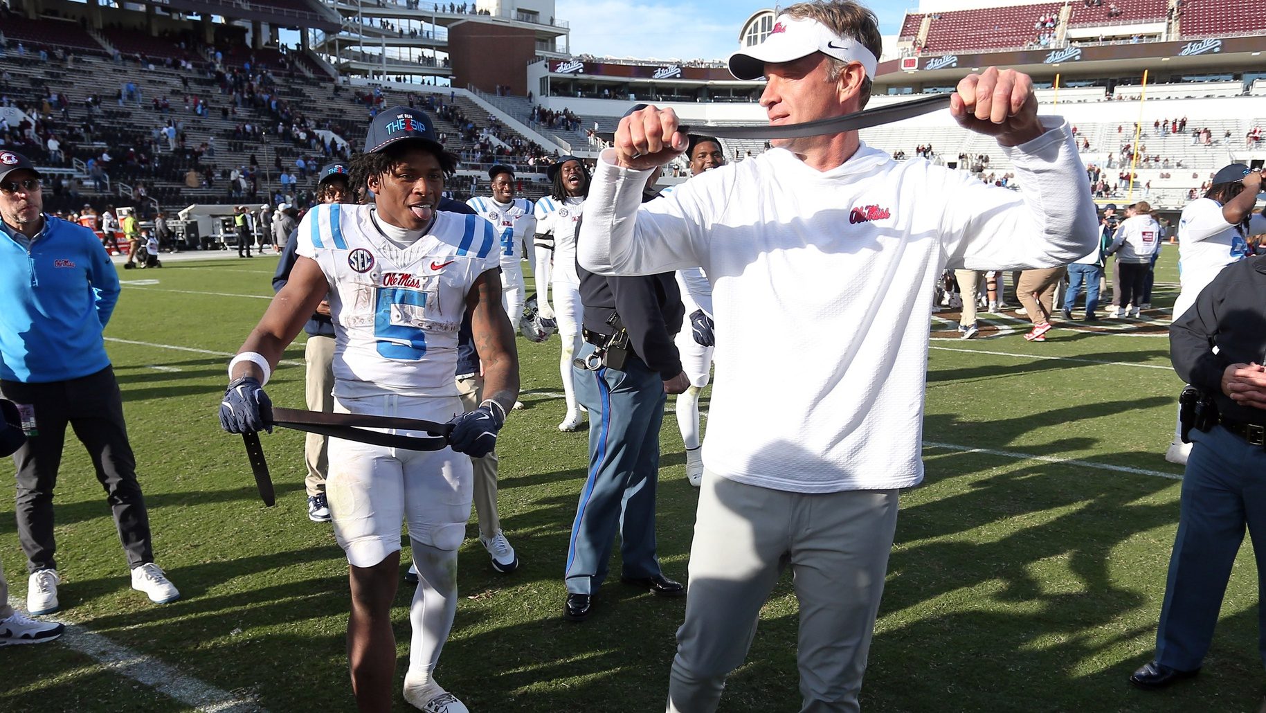 Nov 28, 2025; Starkville, Mississippi, USA; Mississippi Rebels running back Kewan Lacy (5) and head coach Lane Kiffin celebrate after defeating against the Mississippi State Bulldogs at Davis Wade Stadium at Scott Field.
