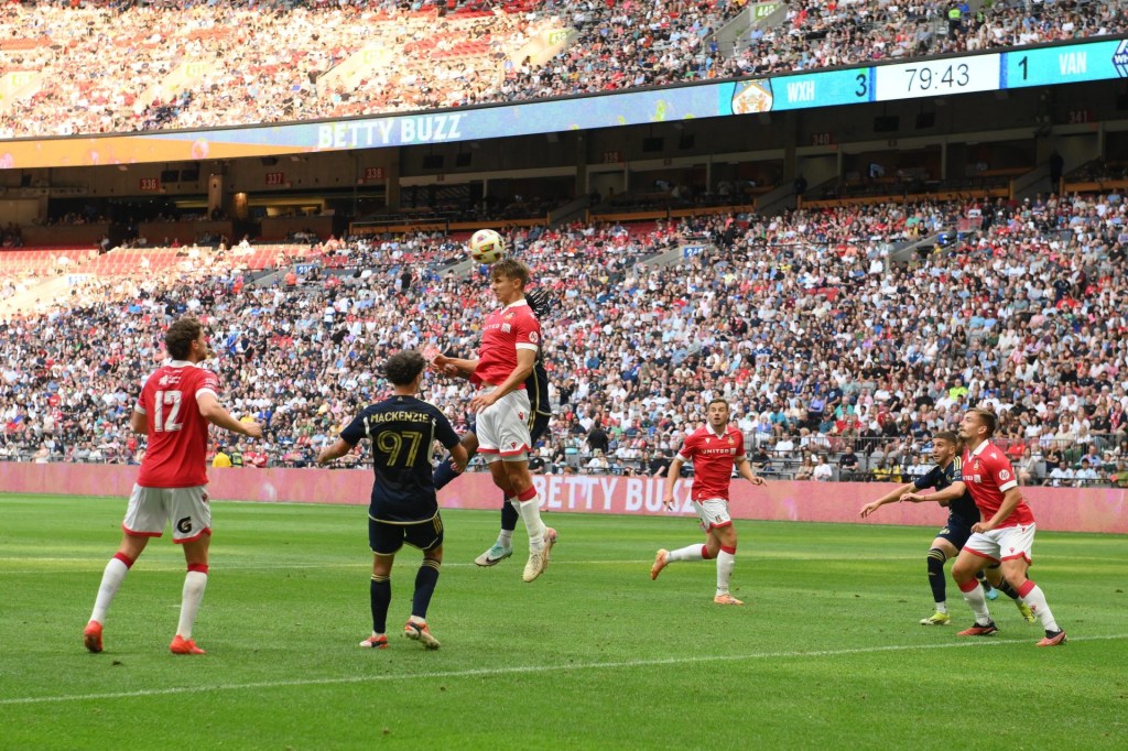 Jul 27, 2024; Vancouver, British Columbia, CAN; Wrexham AFC defender Max Cleworth (4) goes up for a header against Vancouver Whitecaps FC during the second half at BC Place.