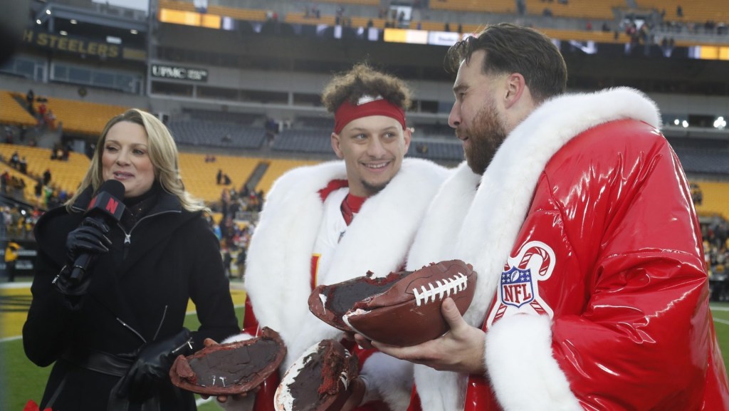 Dec 25, 2024; Pittsburgh, Pennsylvania, USA; Kansas City Chiefs quarterback Patrick Mahomes (middle) and tight end Travis Kelce (right) open their Netflix Christmas GameDay cake after the Chiefs defeated the Pittsburgh Steelers at Acrisure Stadium.