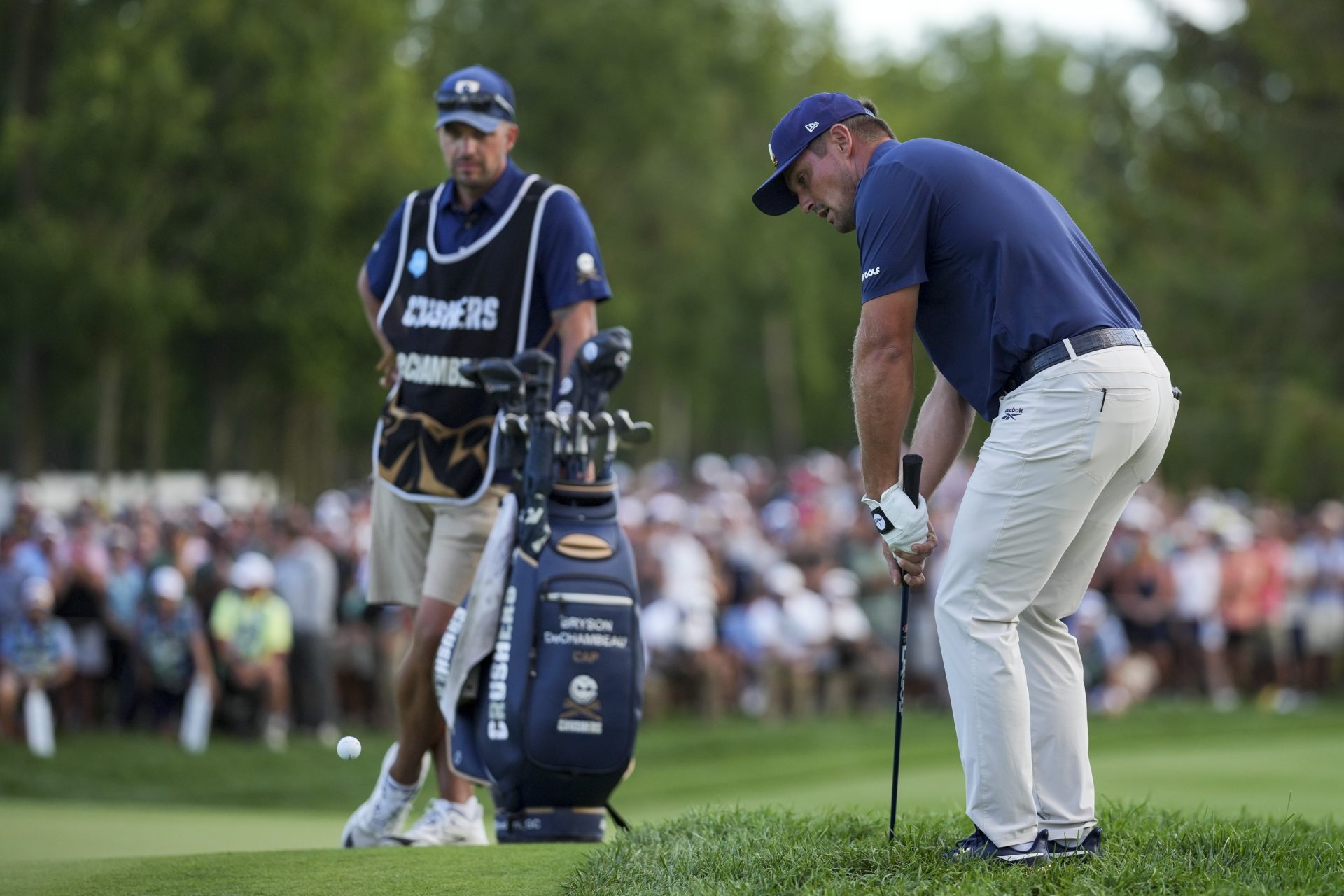 Aug 24, 2025; Detroit, Michigan, USA; Bryson DeChambeau of Crushers GC hits from the rough on the 18th green in a playoff hole during the finals of the LIV Golf Michigan Team Championship at The Cardinal at Saint John's Resort.