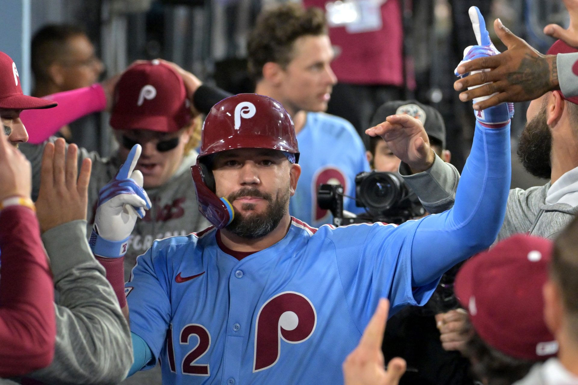 Oct 8, 2025; Los Angeles, California, USA; Philadelphia Phillies designated hitter Kyle Schwarber (12) congratulated in the dugout after hitting a solo home run in the fourth inning against the Los Angeles Dodgers of game three of the NLDS during the 2025 MLB playoffs at Dodger Stadium.