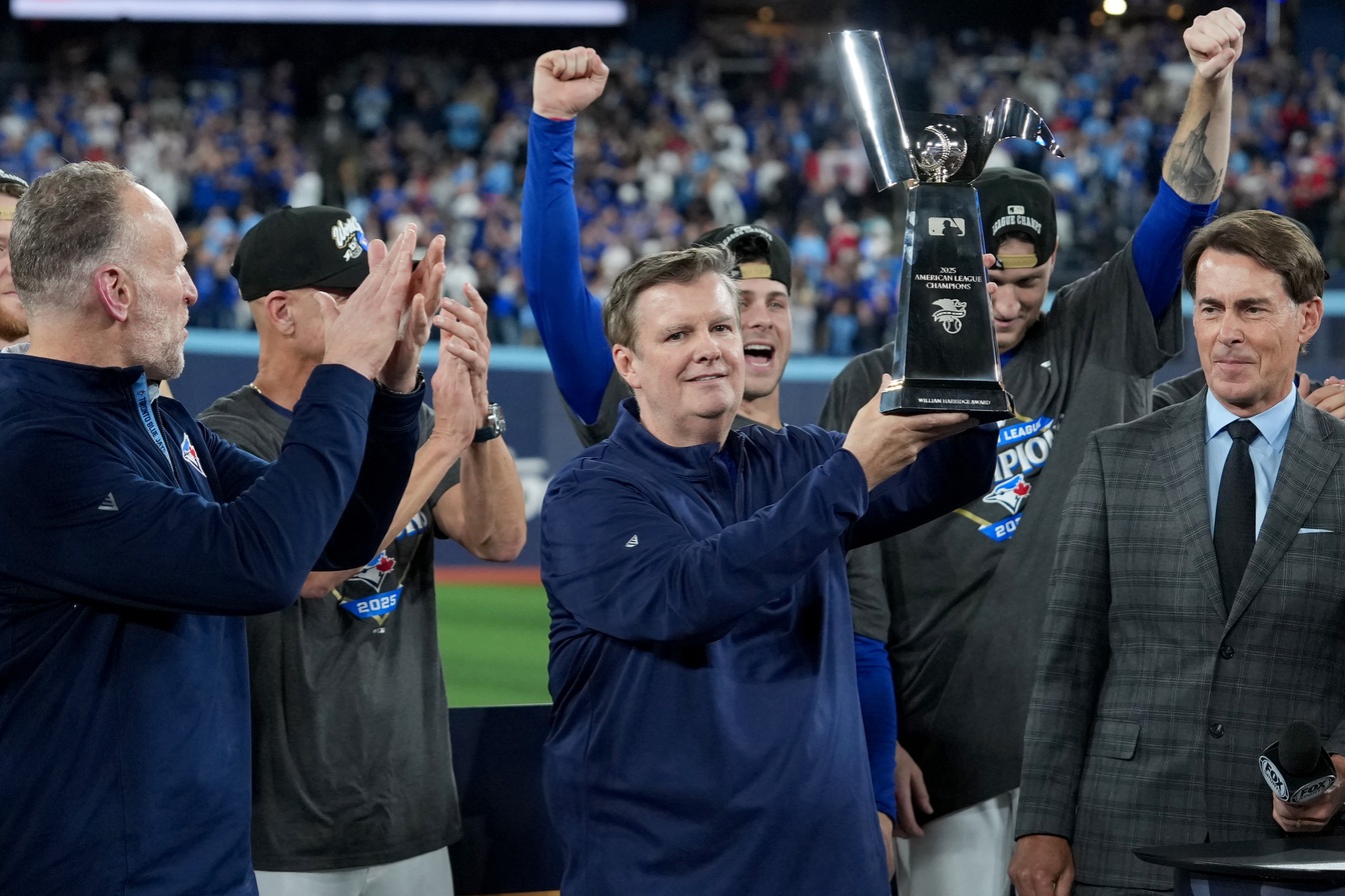 Oct 20, 2025; Toronto, Ontario, CAN; Toronto Blue Jays owner Edward Rogers celebrates with the trophy after the win against the Seattle Mariners in game seven of the ALCS round for the 2025 MLB playoffs at Rogers Centre.