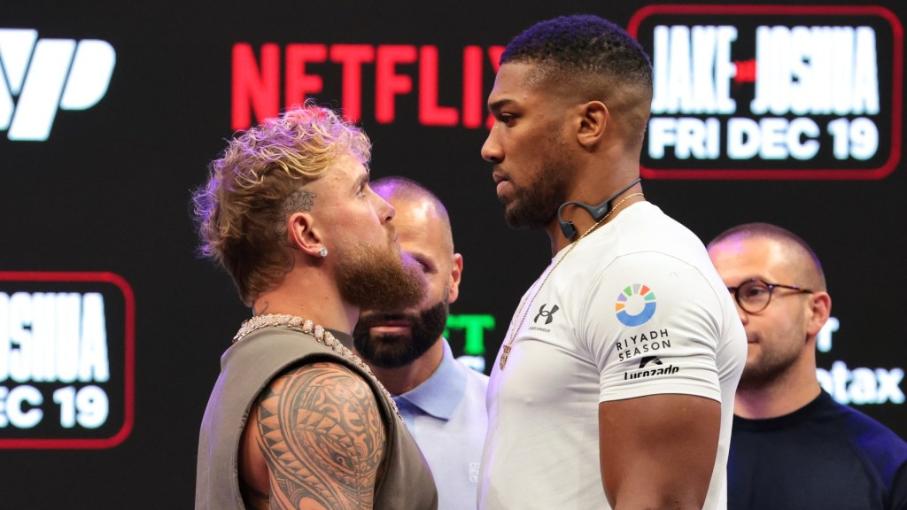 Nov 21, 2025; Miami, Florida, UNITED STATES; Jake Paul and Anthony Joshua face off after a press conference announcing their heavyweight boxing match at Kayesa Center.