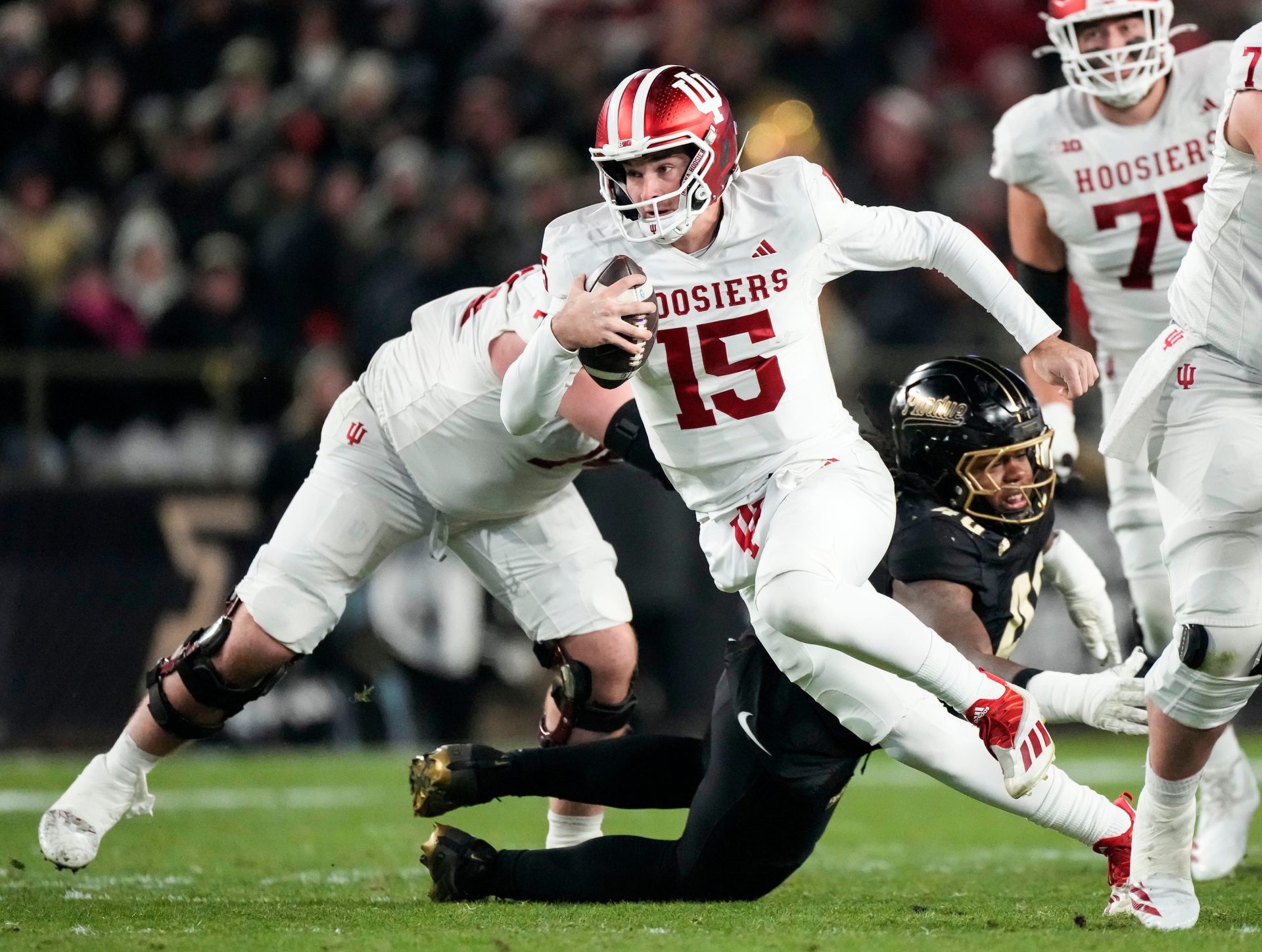 Indiana Hoosiers quarterback Fernando Mendoza (15) rushes up the field Friday, Nov. 28, 2025, during the 100th annual Old Oaken Bucket game at Ross-Ade Stadium in West Lafayette.