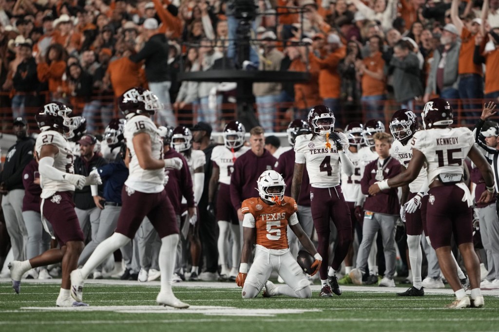 Nov 28, 2025; Austin, Texas, USA; Texas Longhorns running back Quintrevion Wisner (5) reacts after a long run during the second half against the Texas A&M Aggies at Darrell K Royal-Texas Memorial Stadium.