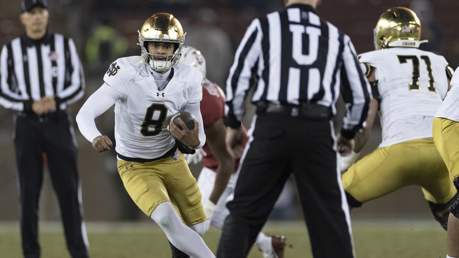 Nov 29, 2025; Stanford, California, USA; Notre Dame Fighting Irish quarterback Kenny Minchey (8) runs with the football during the fourth quarter against the Stanford Cardinal at Stanford Stadium.