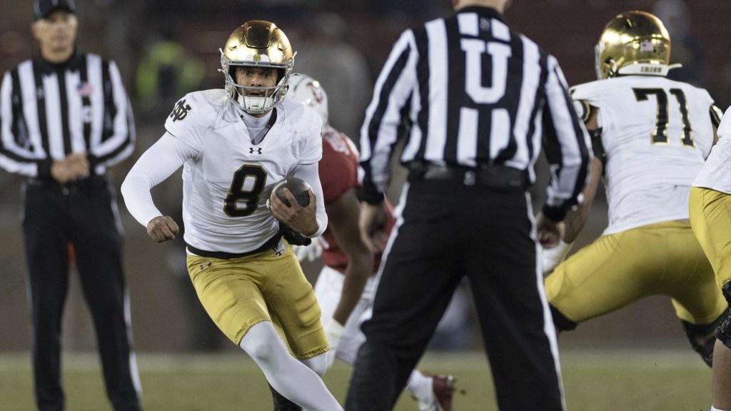 Nov 29, 2025; Stanford, California, USA; Notre Dame Fighting Irish quarterback Kenny Minchey (8) runs with the football during the fourth quarter against the Stanford Cardinal at Stanford Stadium.