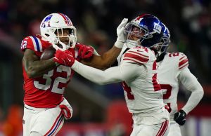 Dec 1, 2025; Foxborough, Massachusetts, USA; New England Patriots running back TreVeyon Henderson (32) runs the ball against New York Giants safety Dane Belton (24) during the fourth quarter at Gillette Stadium.