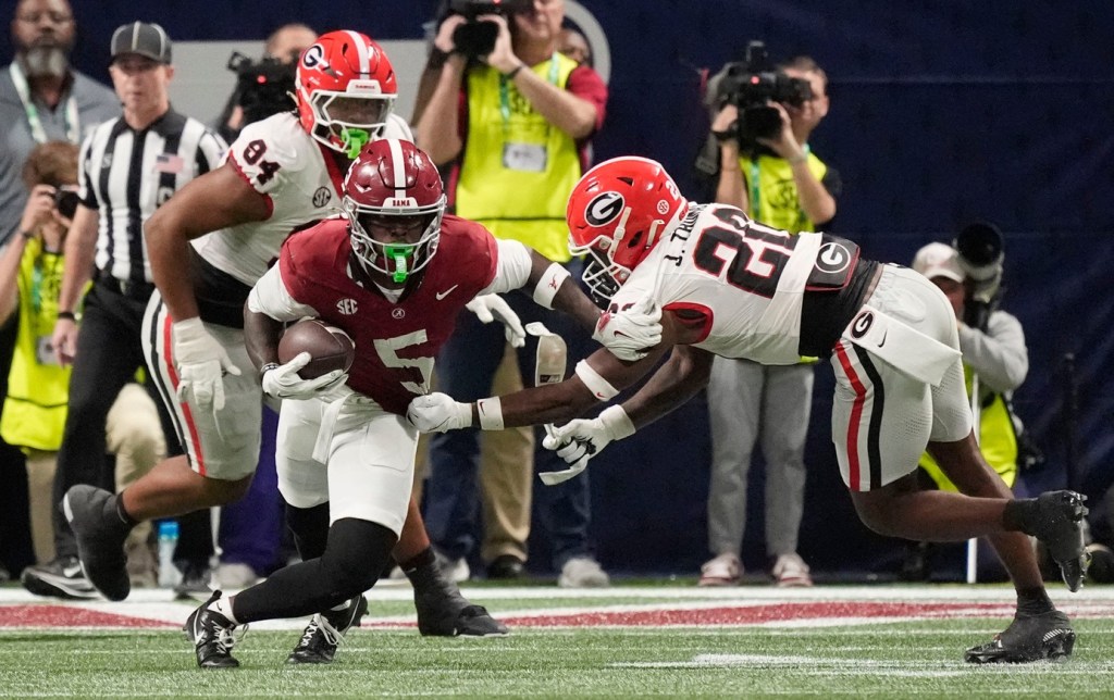 Dec 6, 2025; Atlanta, GA, USA; Georgia defensive back Jacorey Thomas (20) makes a tackle on Alabama wide receiver Germie Bernard (5) at Mercedes-Benz Stadium.