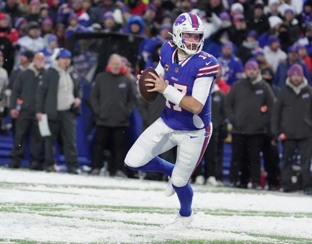 Buffalo Bills quarterback Josh Allen runs with the ball looking to throw to a receiver during second half action at Highmark Stadium in Orchard Park on Dec. 7, 2025