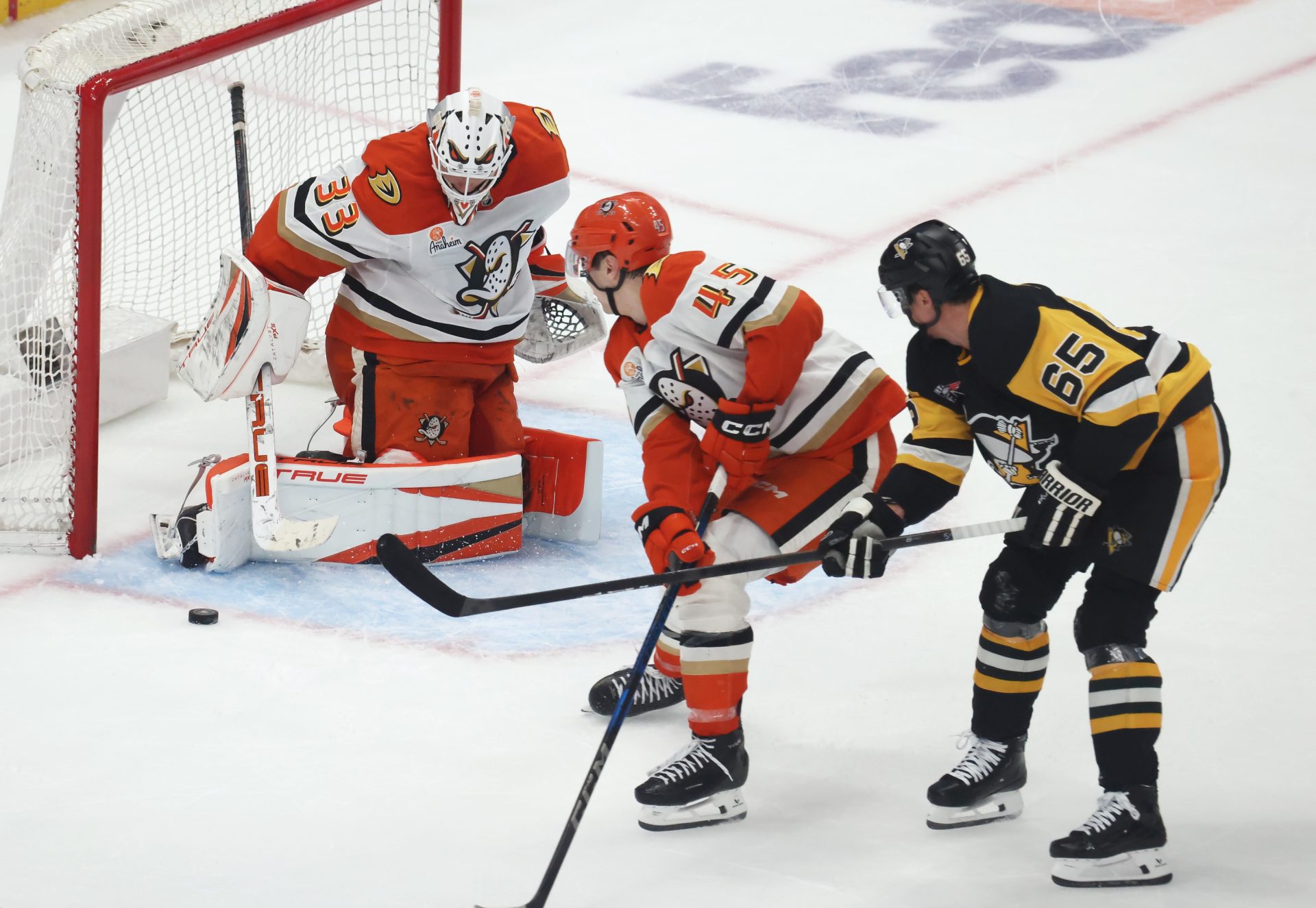 Dec 9, 2025; Pittsburgh, Pennsylvania, USA; Anaheim Ducks goaltender Ville Husso (33) makes a save against Pittsburgh Penguins defenseman Erik Karlsson (65) in overtime at PPG Paints Arena.
