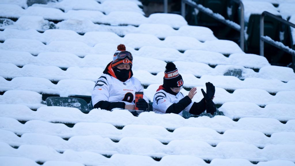 Cincinnati Bengals fans sit in snow-covered seats before the NFL football game between Baltimore Ravens and Cincinnati Bengals at Paycor Stadium in Cincinnati on Dec. 14, 2025.