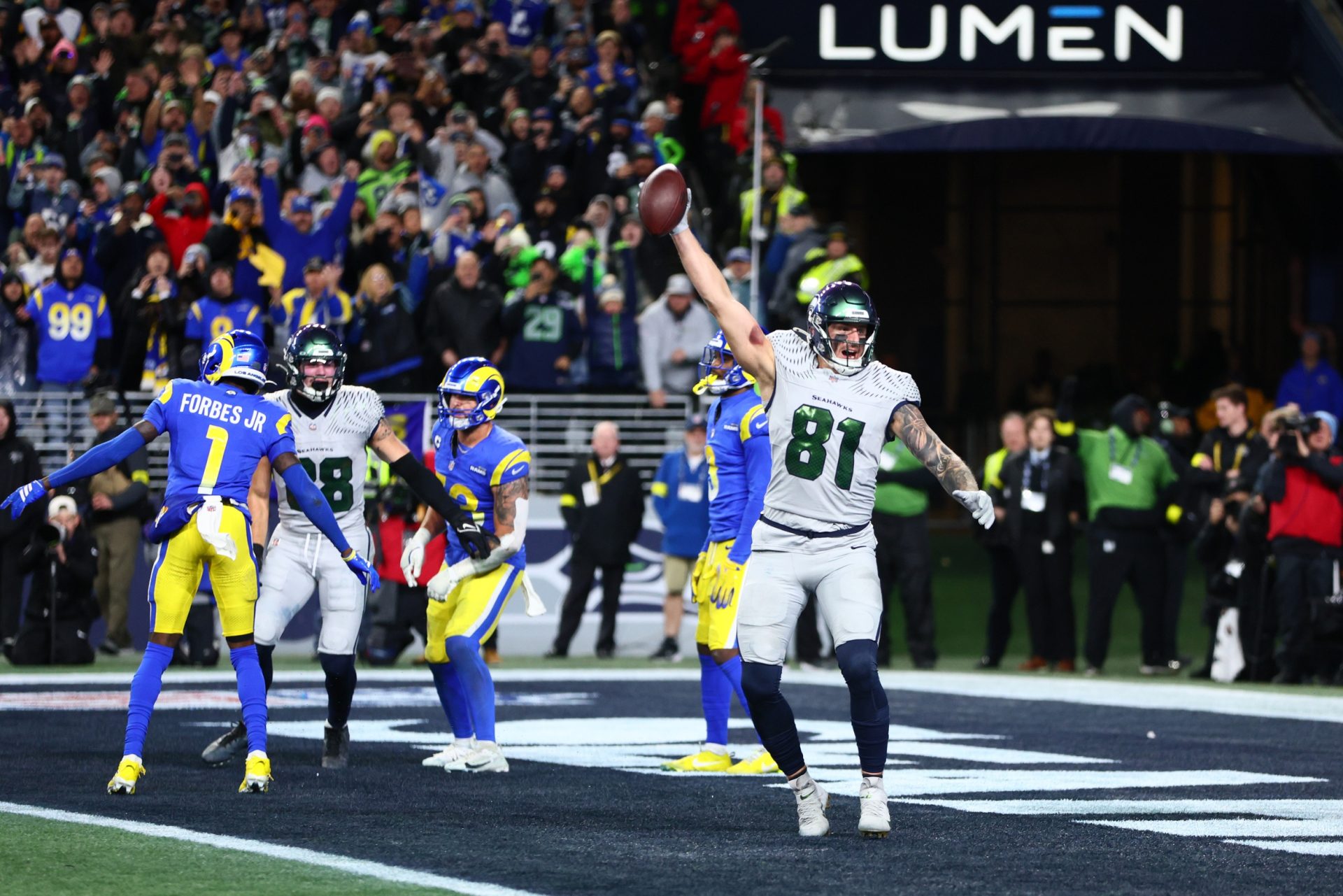 Dec 18, 2025; Seattle, Washington, USA; Seattle Seahawks tight end Eric Saubert (81) celebrates after making a catch for a game-winning two-point conversion against the Los Angeles Rams in overtime at Lumen Field.