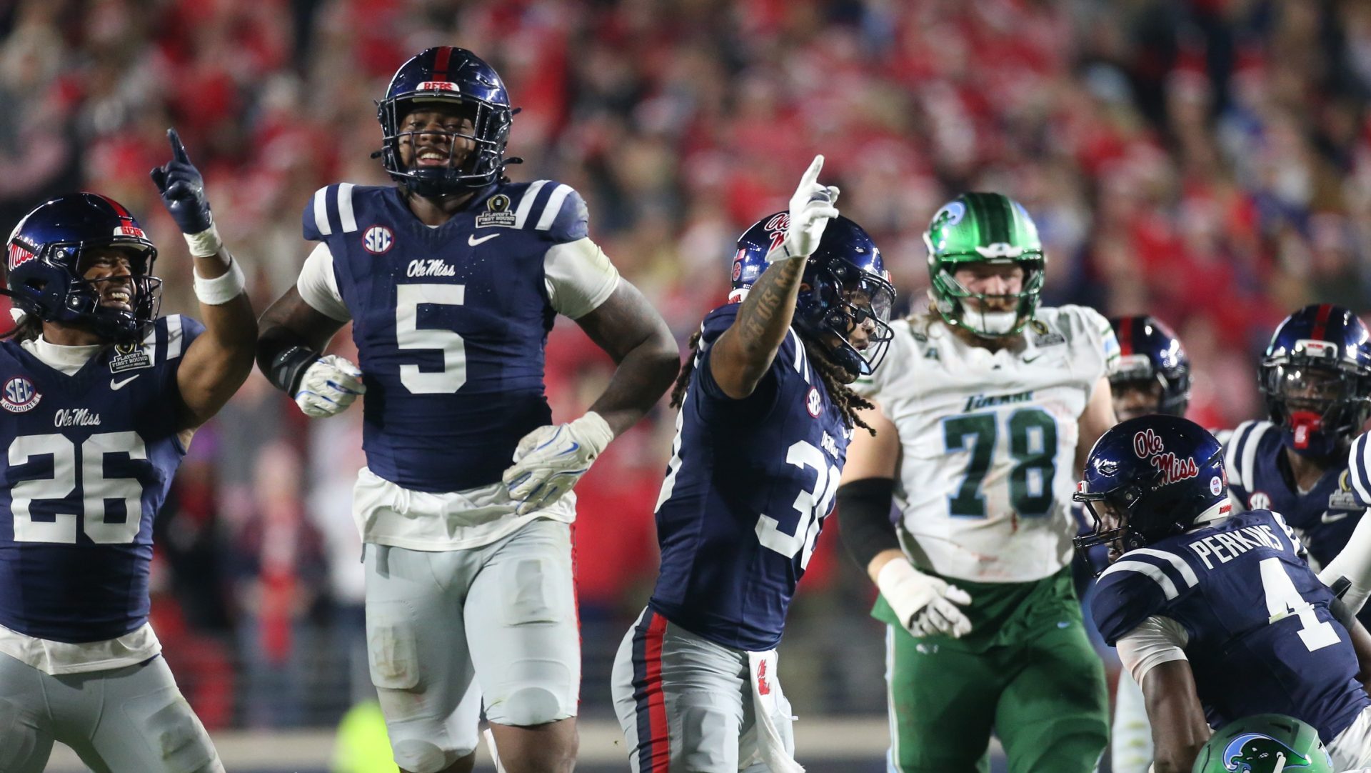 Dec 20, 2025; Oxford, MS, USA; Mississippi Rebels linebacker Tahj Chambers (26), defensive end Kam Franklin (5) and linebacker Jaden Yates (30) reacts after a fumble recovery against the Tulane Green Wave during the second half of a game at Vaught-Hemingway Stadium.