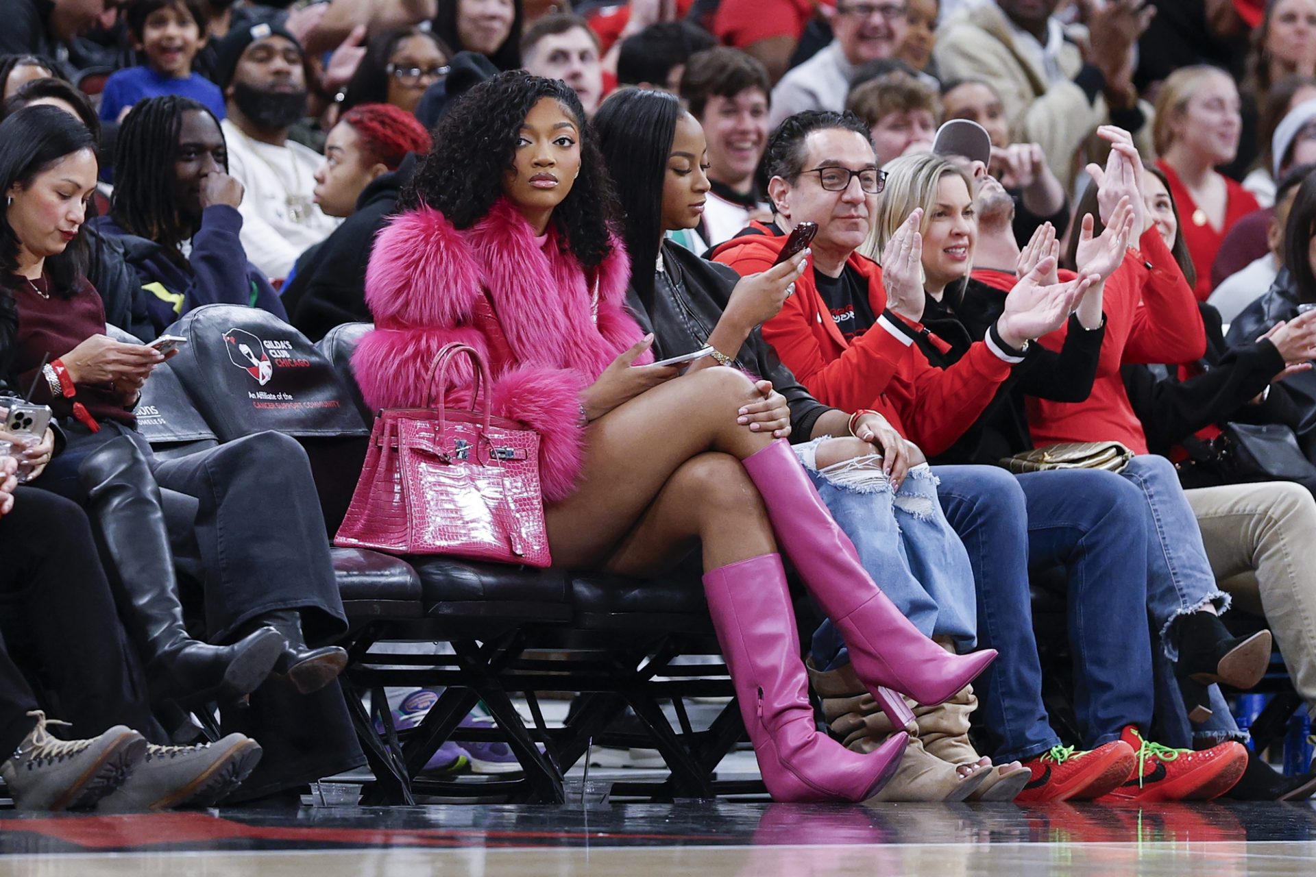 Jan 2, 2026; Chicago, Illinois, USA; Chicago Sky forward Angel Reese watches a NBA game between the Chicago Bulls and Orlando Magic during the first half at United Center.