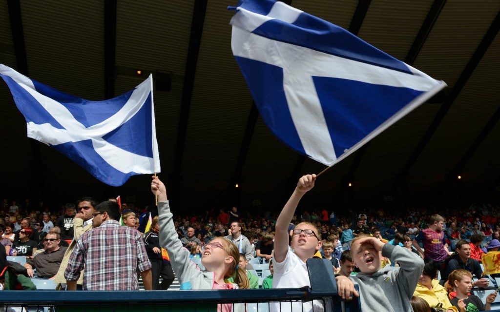 Jul 26, 2012; Glasgow, United Kingdom; Young fans wave Scottish flags during the group D men's preliminary match between Spain and Japan one day before the London 2012 Olympic Games at Hampden Park.