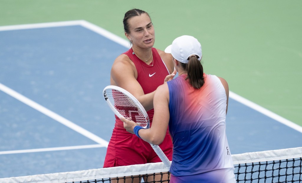 Aug 18 2024; Cincinnati, OH, USA; Aryna Sabalenka at the net with Iga Swiatek of Poland after their match on day seven of the Cincinnati Open.