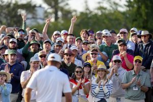 Apr 12, 2025; Augusta, Georgia, USA; Fans cheer for Bryson DeChambeau on the no. 18 green during the third round of the Masters Tournament at Augusta National Golf Club